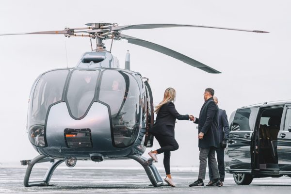 Wealthy couple traveling by a private helicopter